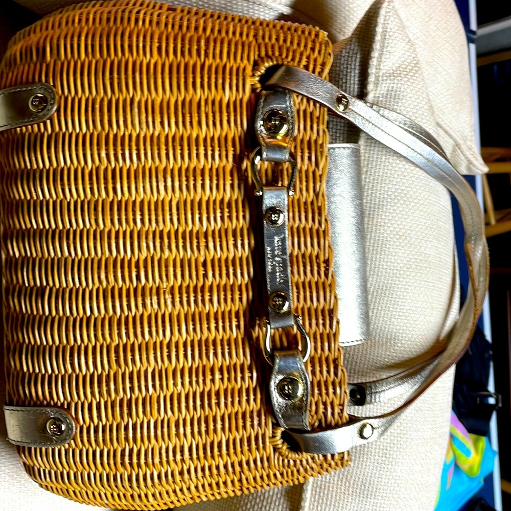 Fun Kate Spade summer bag . Wicker weave exterior and cow pattern interior .